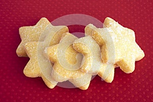 Star biscuits on red background