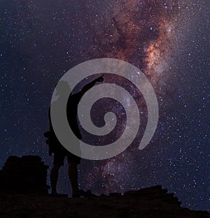 Star-catcher. A person is standing next to the Milky Way galaxy