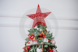 Star on Christmas tree. Christmas decor. Details.Christmas tree decorations homes.