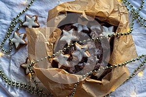 Star cookies in a box decorated with a garland