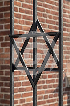 Star of David on metal fence of Old Synagogue in Cracow , Poland