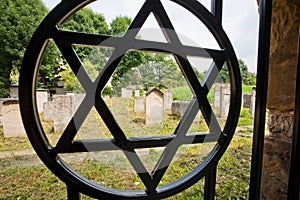 Star of David simbol on the fence of the old Jewish cemetery in the polish city