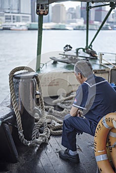 Star Ferry staff sits as the boat crosses Victoria Harbour in Hong Kong