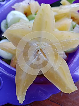 star fruit that is cut in half is yellow