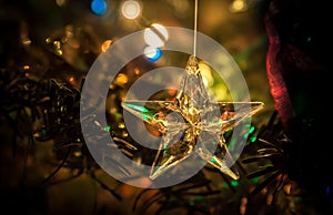 Star of glass with abstract background of holiday lights