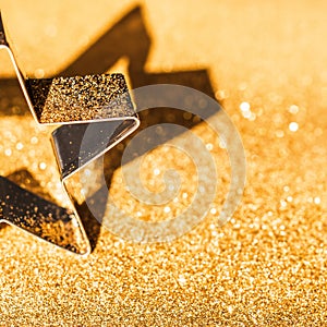 Star on Gold Bokeh Background. Sparkling Christmas Ornament on Glitter Defocused Gold Lights