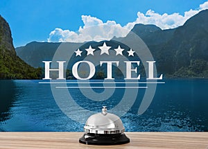 5 Star hotel. Reception desk with service bell and landscape on background