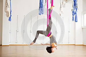 Star Inversion aerial antigravity yoga pose, woman exerciseses with hammock