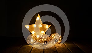 Star lamp with Christmas decoration balls on table top