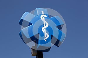 Star of life medical symbol on a pole