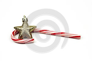 Star ornament laying with a candy cane