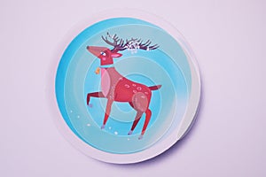A star reindeer in blue circle on white background