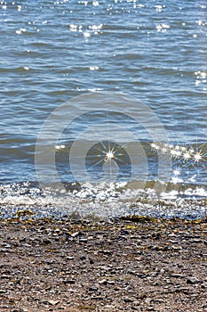 Star shape lens flare on water at the beach