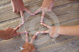 Star shape with six hand fingers on a beach