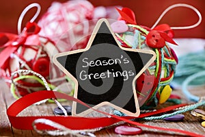 Star-shaped chalkboard with the text seasons greetings
