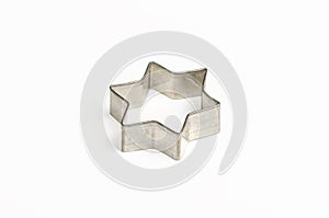 Star shaped Christmas cookie cutter over white