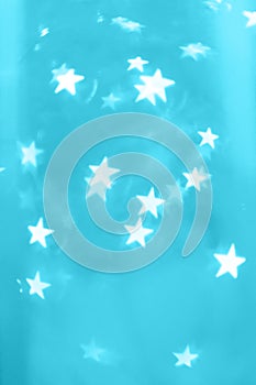 Star shaped Christmas lights on blue cyan background