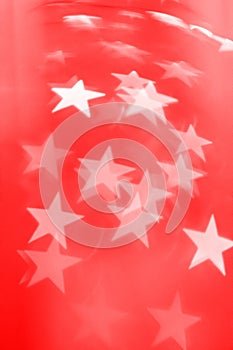 Star shaped Christmas lights on red background