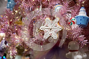 Star shaped ornament on colorful Christmas tree