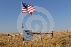 Star spangled banner flag and a message over the couuntryside of South Dakota