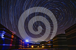 Star trails above desert camp tents