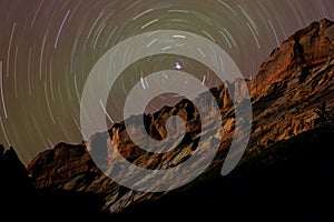 Star Trails around Polaris above Desert Cliffs photo