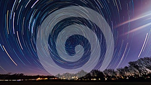 Star trails with lens flare from the moon