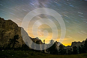 Star trails night sky at twilight hour. Julian Alps, Triglav National Park, Slovenia, Mountain View from Mount Slemenova photo