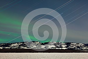 Star trails and Northern lights in moon lit night