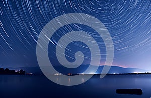 Star trails over the lake photo