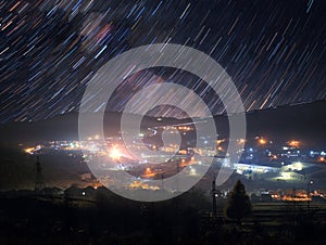 Star trails over mountain town