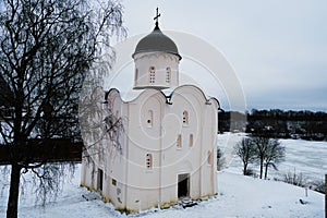 Staraya Ladoga, Russia, January 5, 2019. Beautiful Russian medieval church on the banks of the river on a cloudy winter day.