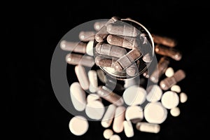 Starch capsules gel caps medication in glass dark background, caplets