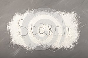 Starch scattered on grey background. Inscription Starch, food ingredient for baking