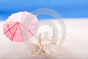 Starfish on the beach under an umbrella