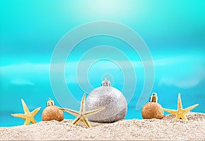 Starfish and Christmas tree shiny balls on beach. Sunny. Concept holiday and recreation, travel in hot countries. New Year