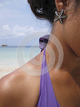 Starfish earing woman on beach photo