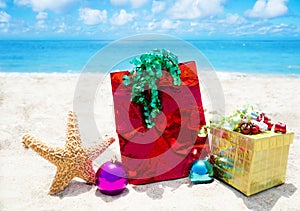 Starfish with gifts and christmas balls on the beach