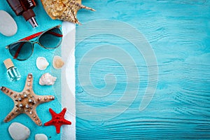 Starfish, pebbles and shells lying on a blue wooden background . There is a place for labels.