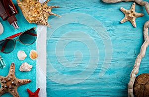 Starfish, pebbles and shells lying on a blue wooden background . There is a place for labels.