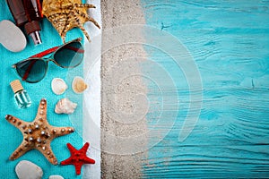 Starfish, pebbles and shells lying on a blue wooden background . There is a place for labels.