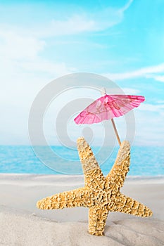 Starfish with pink parasol photo