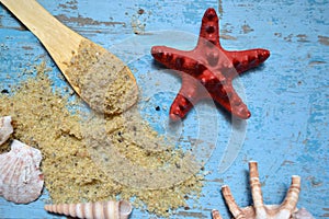 Starfish and sea shells with salt on a blue background.