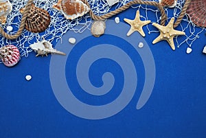 Starfish, Shell, Stones, Rope and Net Against a Blue Background with Copy Space. Summer Holliday. Nautical, Marrine concept.