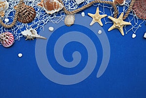 Starfish, Shell, Stones, Rope and Net Against a Blue Background with Copy Space. Summer Holliday. Nautical, Marrine concept. photo