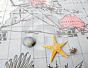 Starfish and shells on pacific map