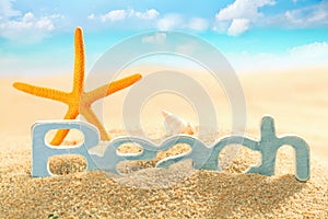 Starfish and sign for Beach in sea sand