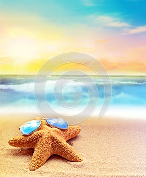 Starfish in sunglasses on the summer beach