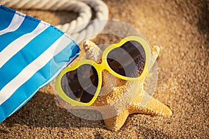 Starfish wearing sunglasses on the beach