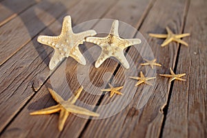 Starfish on a wooden pier poured over a wooden deck. Summer vacation concept. Holidays by the sea